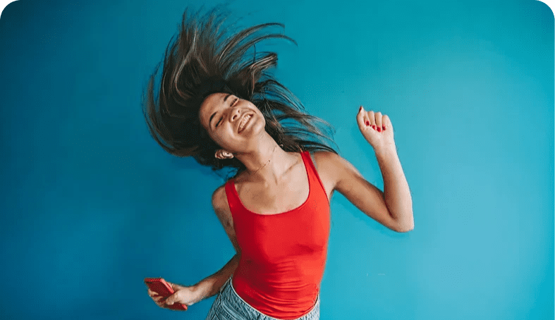 Woman joyfully dancing with hair in motion